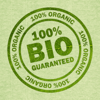 Round stamp with 100% Bio - organic guaranteed - green leaf structure on green laid paper. Symbol for genuine products
