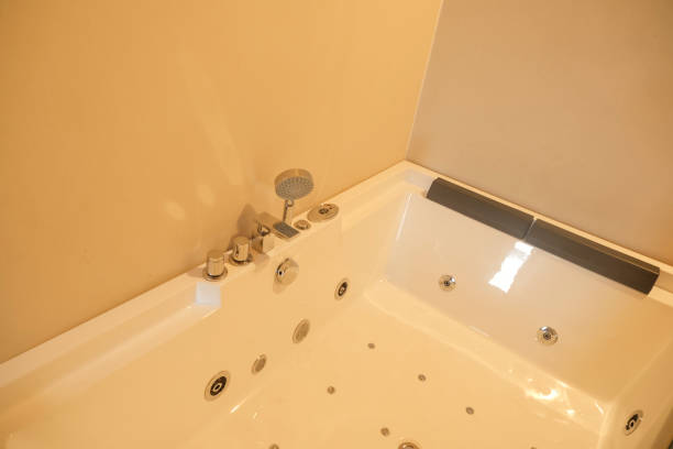 istock White hot tub in a hotel closeup. Bathroom interior 1811382244