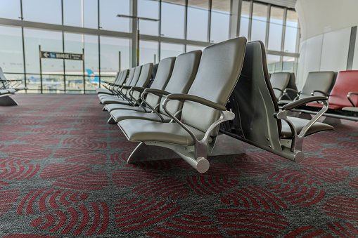 empty airport terminal waiting area with chairs