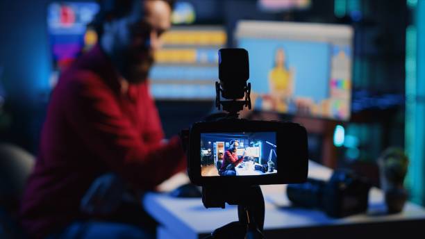 istock Focus on camera recording photographer in blurry background presenting his work 1811388932
