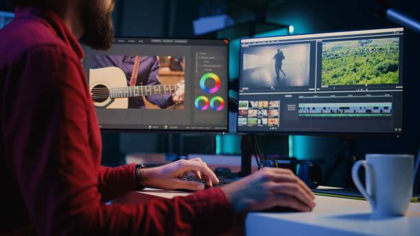 istock Video editor inputting music, dialogues, graphics and effects over raw footage 1811396075