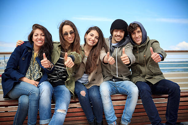 Cheerful teenagers with thumbs up stock photo