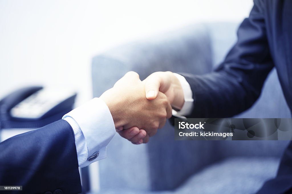 Business Handshake Close-up of businessman and businesswoman handshaking in an office environment. Achievement Stock Photo