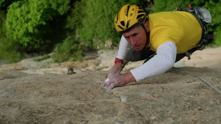 The Fearless Climber Ascending the Majestic Rock Formation