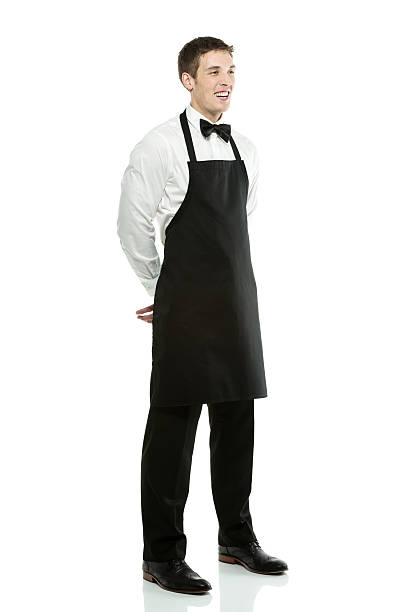 istock Smiling young waiter posing against white 181140268