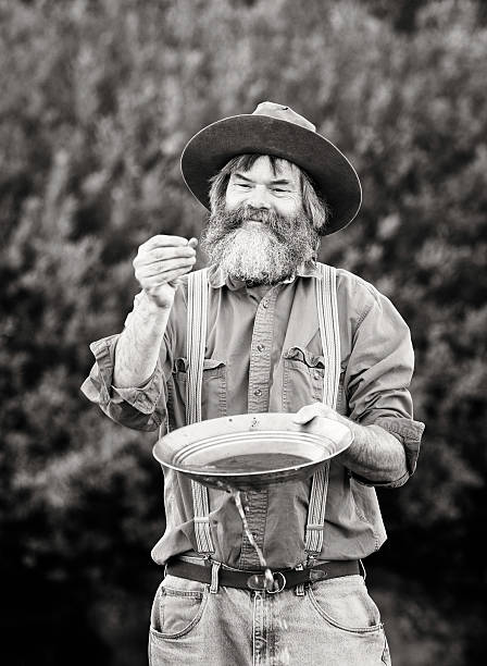 istock Mature prospector panning for gold vertical 181140289
