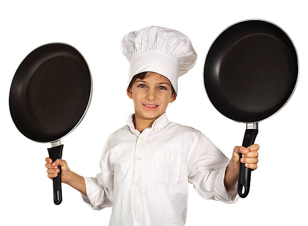 istock Smiling Little Cook With Two Frying Pans 181140351