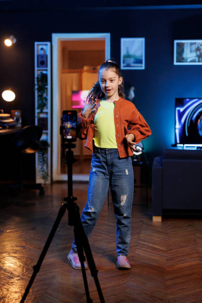 istock Joyful kid entertains subscribers with professional choreography recorded with mobile phone 1811406837