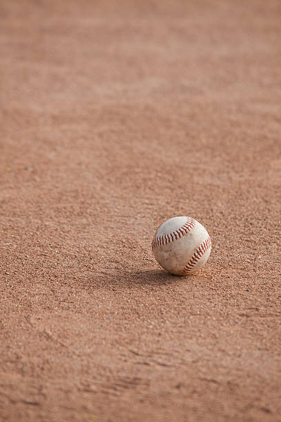 istock Softball sitting on the infield dirt 181140842