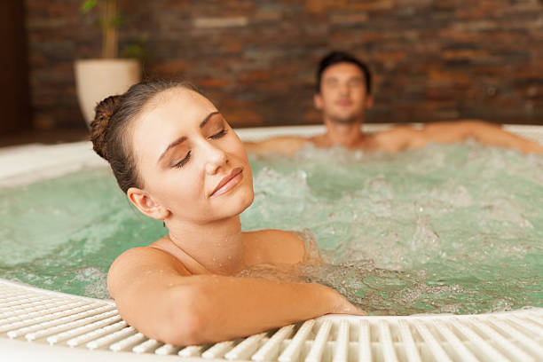 istock Young couple relaxing in hot tub 181142258