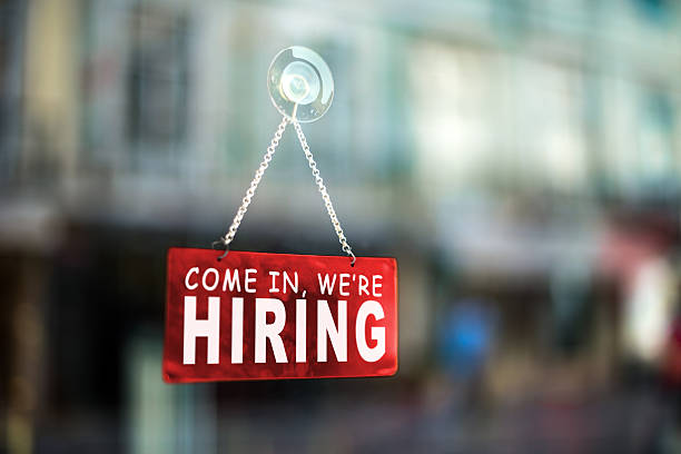come in we're hiring come in we're hiring sign on window help wanted sign photos stock pictures, royalty-free photos & images