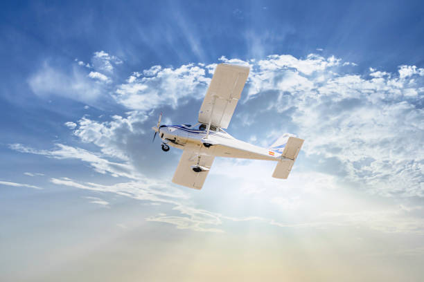 istock Light aircraft flying over blue sky 1811426644
