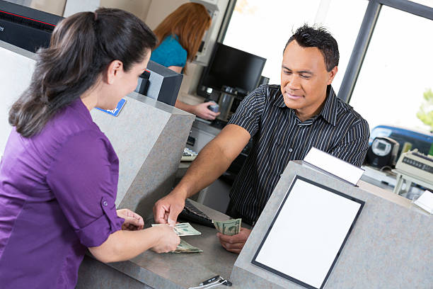 Customer at the bank getting money from teller