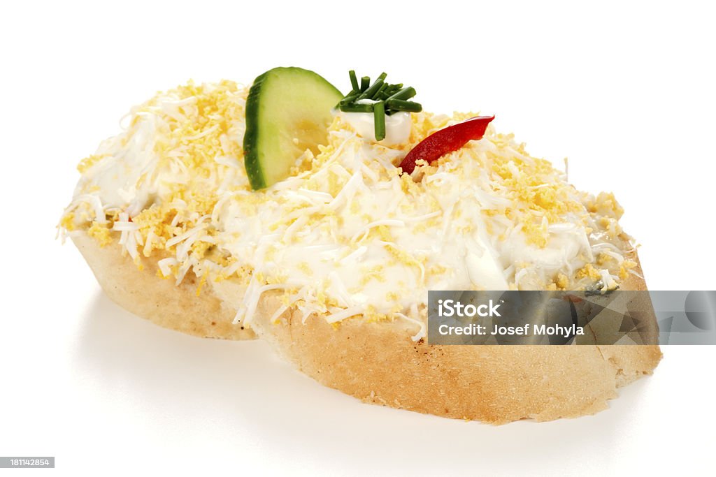 Open sandwich with grated egg Open faced sandwich with grated egg, potato salad, mayonnaise, cucumber, pepper and  chives on white background. Selective focus, shallow DOF. Appetizer Stock Photo