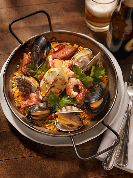 paella di pesce - seafood lobster paella prepared shellfish foto e immagini stock