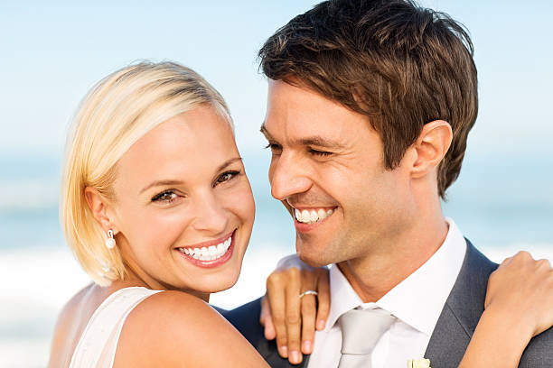 istock Beautiful Bride Embracing Groom On Beach 181143363