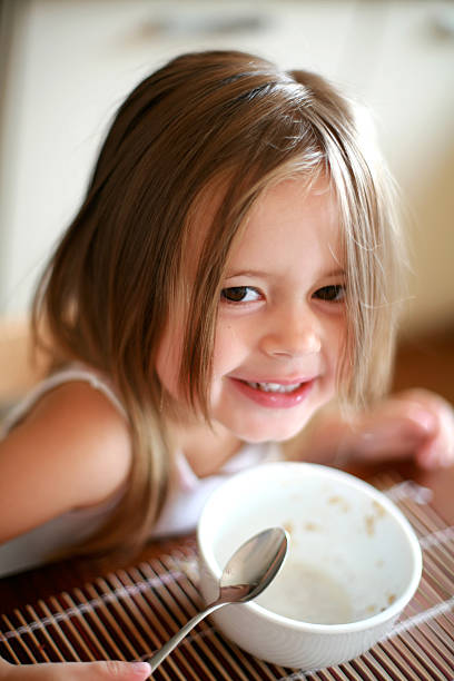 istock Little girl eating breakfast 2 181144018