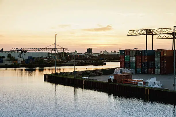 harbor area with commercial dock, many containers,  in Dortmund, Germany at dusk