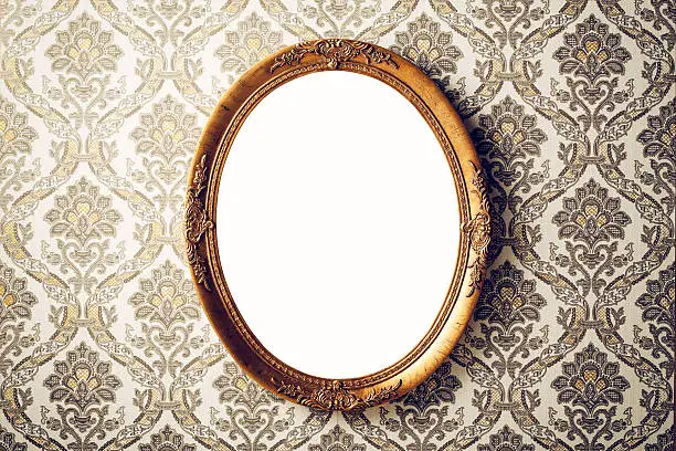 Vintage picture frame on baroque style wallpaper.