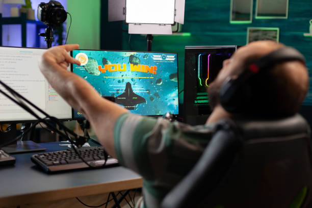 istock Concentrated streamer playing space shooter game 1811441253