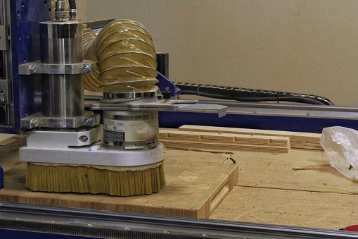 Craft carpentry workshop with variety of wooden pieces and planks, work bench in the foreground. Joinery with workbench and lots of wood. Carpenters equipment machine with furniture details