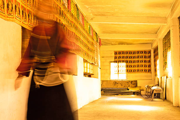 Monks in Tibetan Buddhism temple Monks turned prayer wheel in Tibetan Buddhism with sunlight prayer wheel nepal kathmandu buddhism stock pictures, royalty-free photos & images