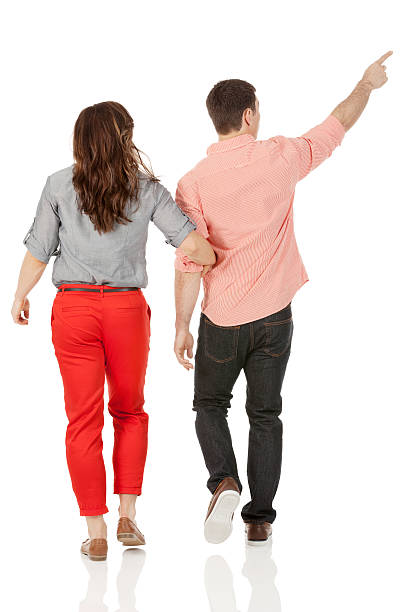 istock Rear view of a couple walking while man gesturing 181144664