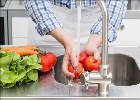 Washing vegetables in kitchen sink