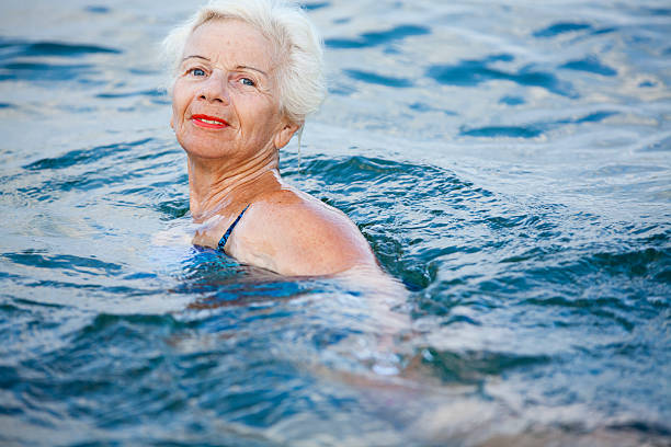 istock Active senior woman in swimming pool 181145074