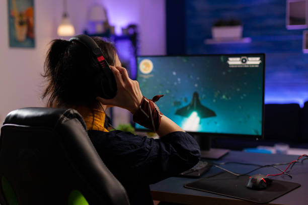 istock Focused Gamer puts professional headphones and playing 1811453907