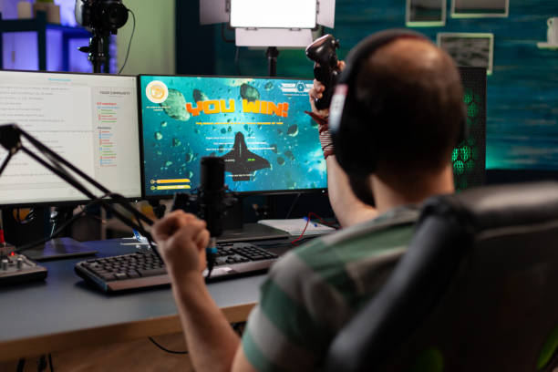 istock Streamer man talking with multiple players into headphones 1811454509