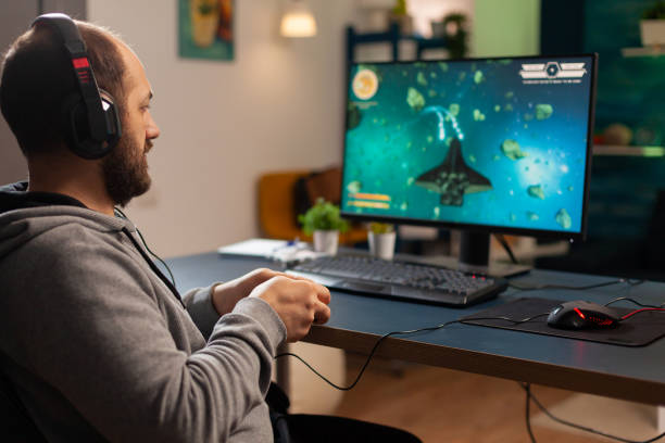 istock Pro man gamer playing video game at professional computer 1811456202