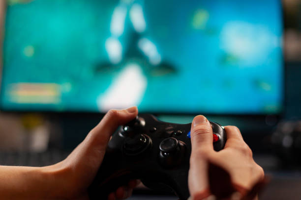 istock Close up of wireless console, player playing online space shooter game 1811464820
