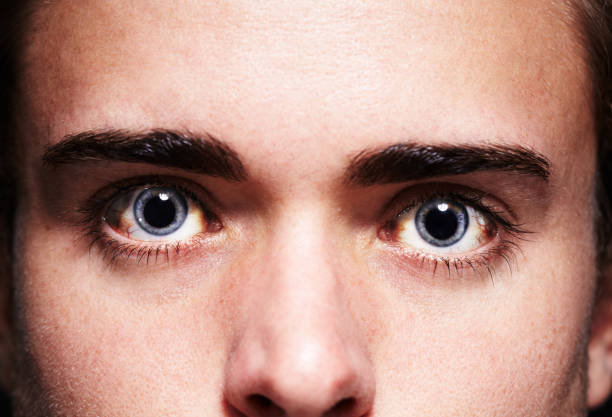 High as a kite Closeup portrait of a young man's face with dilated pupils drunk visual stock pictures, royalty-free photos & images