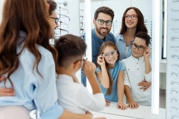 istock Happy parents and kids looking at mirror in optical store 1811471382
