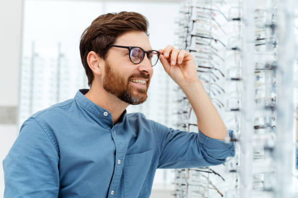 istock Happy male customer choosing spectacles at optic store 1811471930