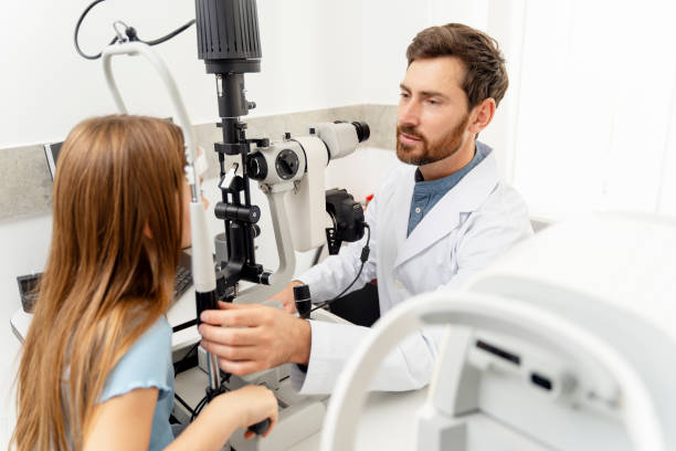 istock Little girl visiting a doctor while having her eyesight checked in optics 1811472496