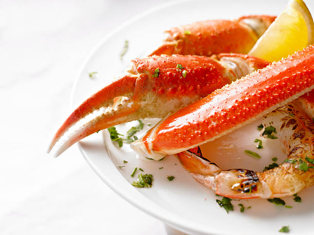 King Crab Dinner King Crab Plate with Grilled Prawn. crab leg photos stock pictures, royalty-free photos & images