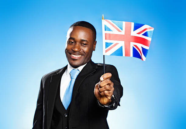 istock Smiling citizen waves the British flag 181147434