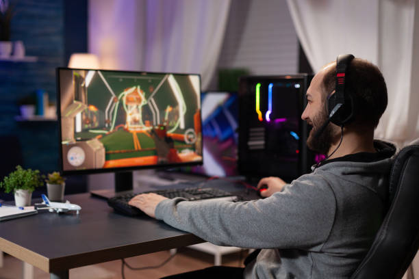 istock Gamer with headset playing video games on computer 1811474845