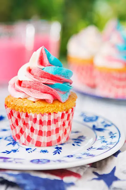 Red-white-and-blue cupcakes on an outdoor table.