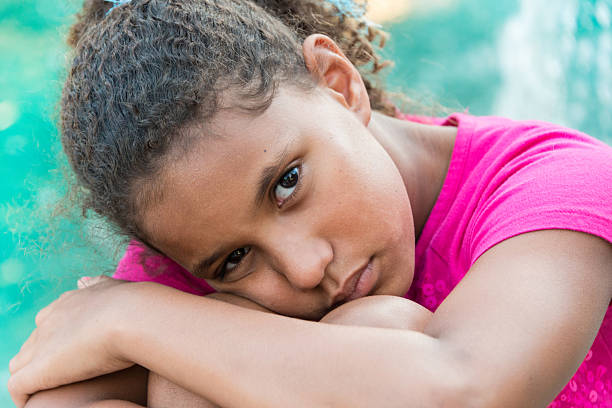 Sad Girl Sad nine years old afro caribbean nine years old girl sad girl crouching stock pictures, royalty-free photos & images