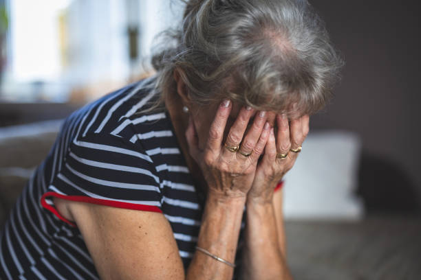 Depressed Senior Woman Covered Her Face With Both Hands