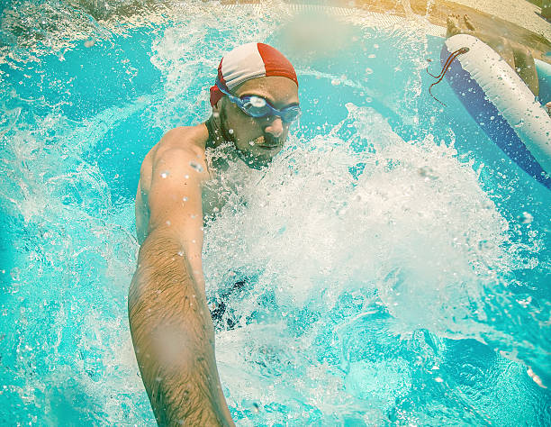 istock Man jumping and diving in swimming pool 181147798