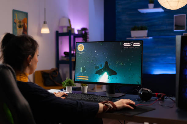 istock Person using keyboard and mouse to play video games 1811478672