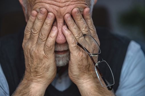Depressed Senior Man Covered His Face With Both Hands