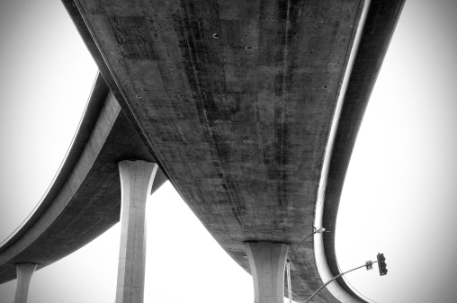 The junction of two freeways turning to one shot from below.  Vignette and slight film grain added for effect.Others in this series: