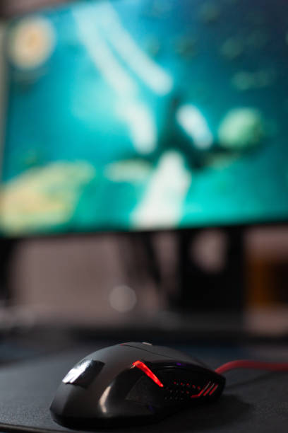 istock Close up of mouse in front of computer on desk 1811482125