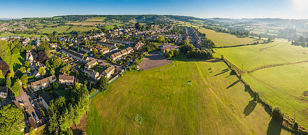Aerial panorama over suburban homes school fields idyllic summer landscape