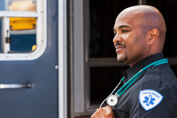 istock Paramedic standing by ambulance 181148707